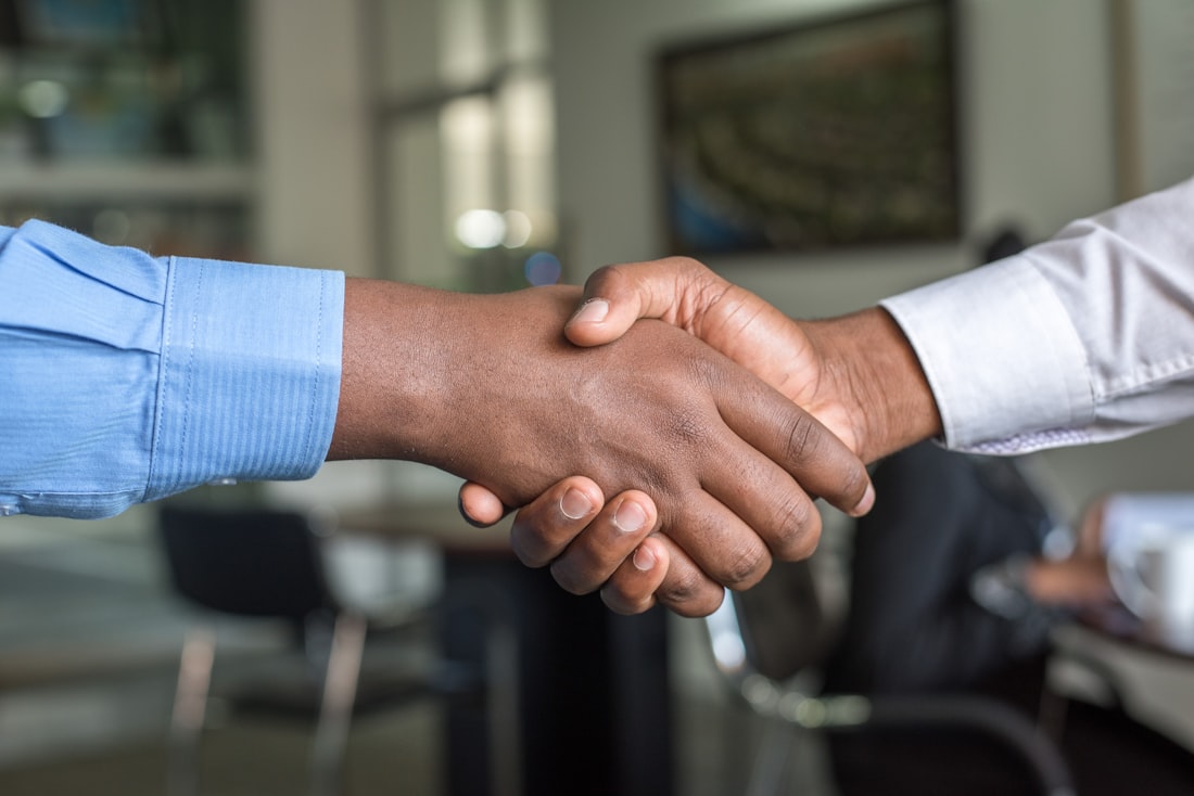 A professional team in conversation, planning a cleaning program with a client.
